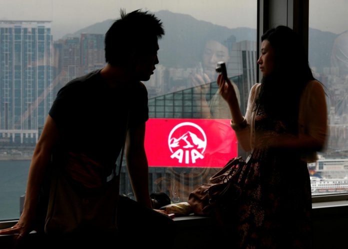 FILE PHOTO: A couple tours inside the Bank of China Tower opposite to AIA Central building in Hong Kong